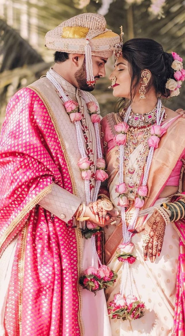 Traditional carved wedding mandap with floral garlands